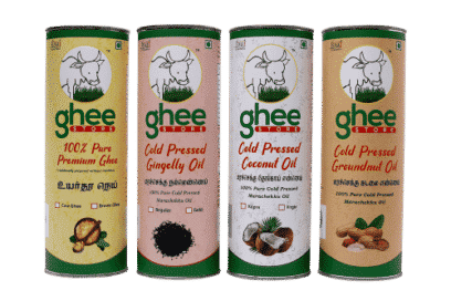 Four Cylindrical Containers Of Ghee Store Products, Each Labelled With Different Contents: 100% Pure Premium Ghee, Cold Pressed Gingelly Oil, Cold Pressed Coconut Oil, And Cold Pressed Groundnut Oil.