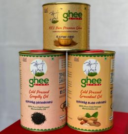 Three Cylindrical Tins From Ghee Store; Two Contain Cold Pressed Oils (Gingelly Oil And Groundnut Oil) And One Contains 100% Pure Premium Ghee.