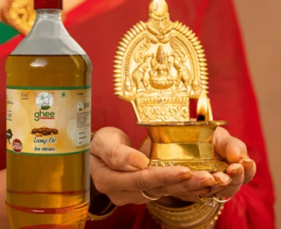 Woman Holding A Brass Oil Lamp And Bottle Of Lamp Oil.