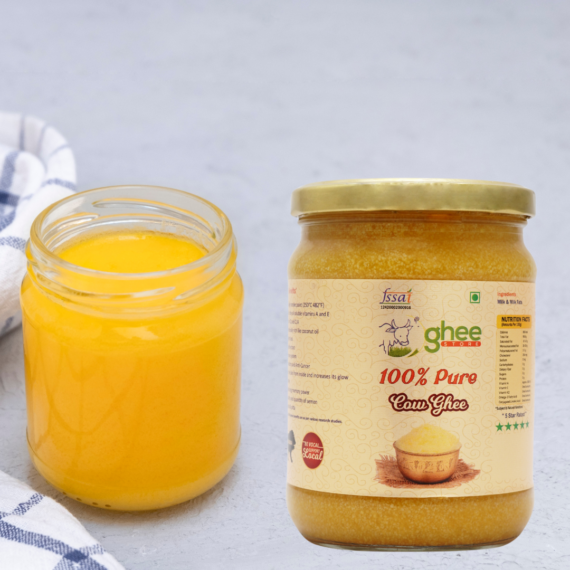 Desi Cow Ghee 1 Kg Price - Pure A2 Bilona Method Ghee. Two Jars Of Cow Ghee, One Open And One Sealed, Placed On A Light Grey Surface With A White And Blue Checkered Cloth Nearby.