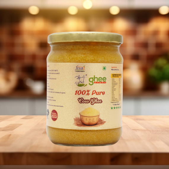 Desi Cow Ghee 1 Kg Price - Pure A2 Bilona Method Ghee. Jar Of 100% Pure Cow Ghee On A Wooden Surface With A Blurred Background.