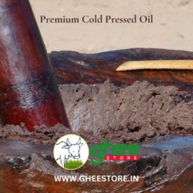 A Close-Up Of A Traditional Wooden Cold Press With The Text &Quot;Premium Cold Pressed Oil&Quot; And A Website Url &Quot;Www.gheestore.in.