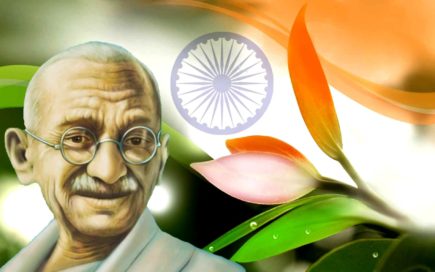 Portrait Of An Elderly Man With Glasses, With The Indian Flag And Flowers In The Background.